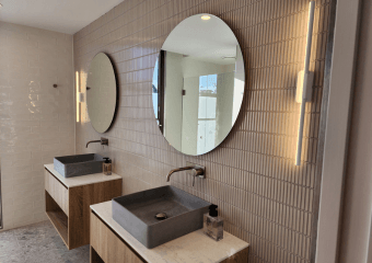 Timber vanity, concrete basin and round mirror